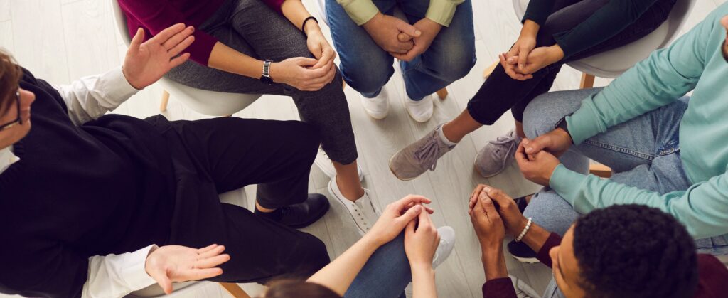 A group therapy session. what is a sober living house?